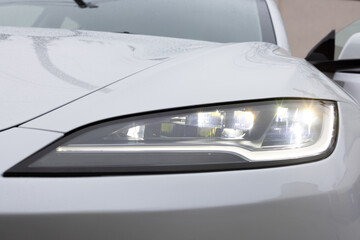 Modern car headlamp flashing light with blinking on continuously indicator. Switched on led matrix lights of luxury car. Car Blinker Light. Car front full led matrix IQ Light