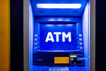 Illuminated automated teller machine at night.