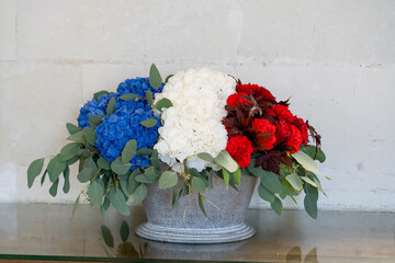 an arrangement of blue, white and red flowers to symbolise the French tricolore