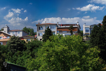 Beautiful houses and city streets of the southern city with green plants, public place in Turkey, on a summer sunny day