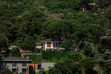 Beautiful houses and city streets of the southern city with green plants, public place in Turkey, on a summer sunny day