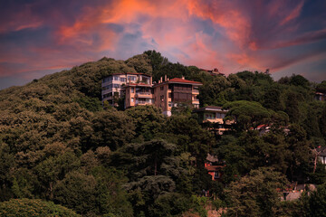 Evening view of the city. Sunset orange sky and beautiful landscape, houses and city streets, public place in Turkey