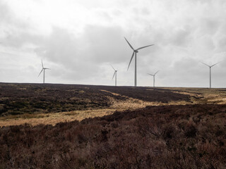 Wind turbines farm on the bleak Yorkshire moors. Power generation on a barren land in England....
