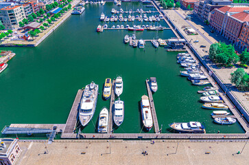 Aerial top view of harbour with yachts motor boats moored near quay in marina, embankment promenade of Bonaparte Dock in Antwerp city, Antwerpen port area, Flemish Region, Belgium