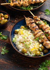 Greek grilled chicken skewers served with lemon rice and marinated green olives