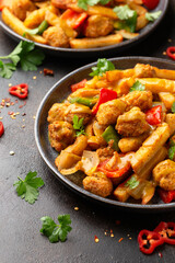 Irish spice bag take away food with potato fries, fried chicken, vegetables and curry sauce