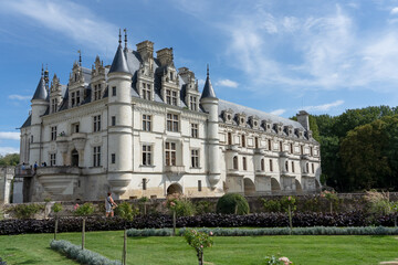 a large white country mansion with normandy style turrets, Chateau de Chenonceau Castle, France