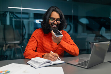 Casually dressed man recording voice note