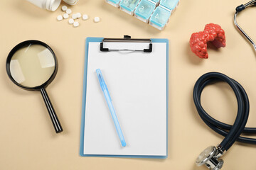 Endocrinology. Flat lay composition with clipboard and model of thyroid gland on beige background - obrazy, fototapety, plakaty