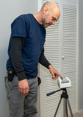 Home inspector doing a radon test setup in the lowest bedroom of a home.