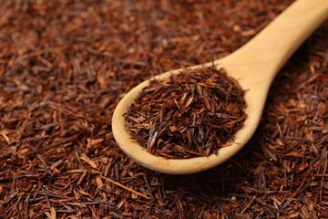 Rooibos tea and wooden spoon, closeup view
