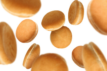 Fresh burger buns falling on white background
