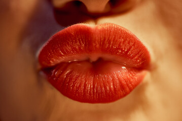 A girl kisses sexy with lips that are painted with red lipstick