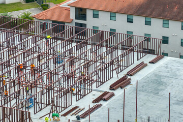 Development of real estate market in the USA. Large construction site with workers and building...