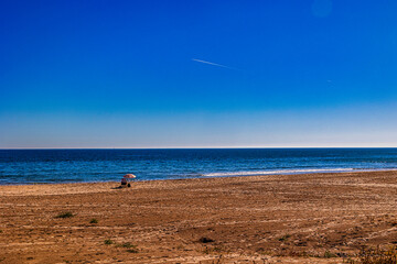 Fototapeta na wymiar empty beach with one lounger holiday landscape