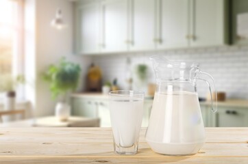 Tasty fresh Milk in jug and cup on the desk