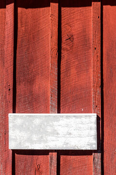 Exterior vintage red barn 
wood texture with empty white panel

