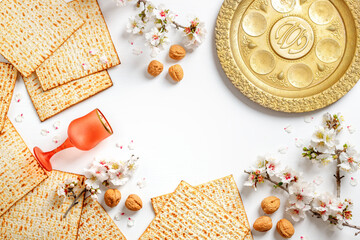Matzo, decorated with almond flowers. On a white background. Pesach celebration concept
