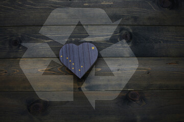 wooden heart with national flag of alaska state near reduce, reuse and recycle sing on the wooden...