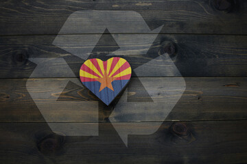 wooden heart with national flag of arizona state near reduce, reuse and recycle sing on the wooden...