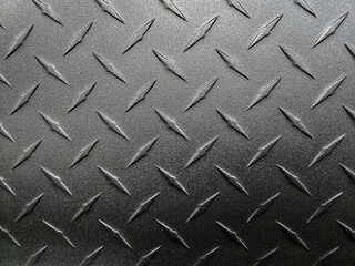 Close-up of brushed dark gradient gray aluminum metal diamond plate design