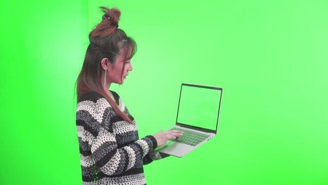 Female using laptop computers. Young woman on green screen background.