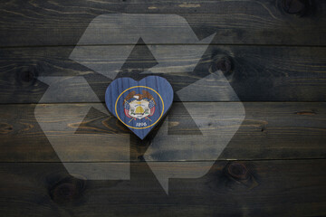 wooden heart with national flag of utah state near reduce, reuse and recycle sing on the wooden...