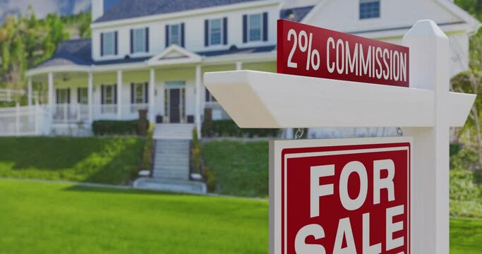 2% Commission For Sale Real Estate Sign with a New Home in the Background.
