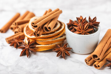 Cinnamon sticks and anise on a textured background. Cinnamon roll and star anise. Spicy spice for baking, desserts and drinks. Fragrant ground cinnamon.Place for text. copy space.