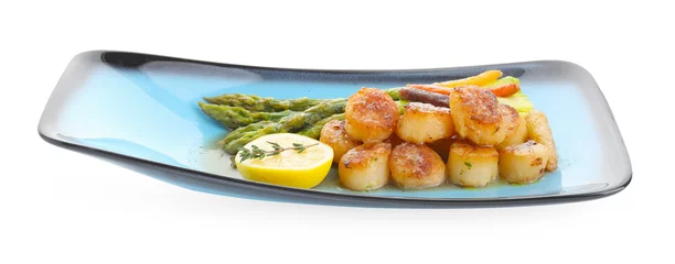 Foto op Canvas Delicious fried scallops with asparagus, vegetables, lemon and thyme isolated on white © New Africa