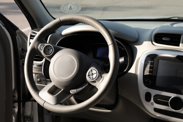 Black steering wheel and dashboard in modern car