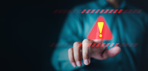 firewall, security, information, problem, presenting, exclamation, mark, expression, beware, warning. A man is pressing a red button with a red triangle on it. Concept of urgency and danger.