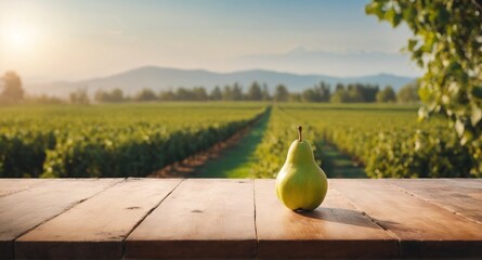 Pear fruits on wooden table, field garden in background. - obrazy, fototapety, plakaty