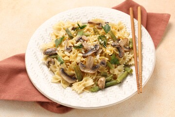Vegetarian pasta with mushrooms, parsley, string beans and cheese on orange textured table