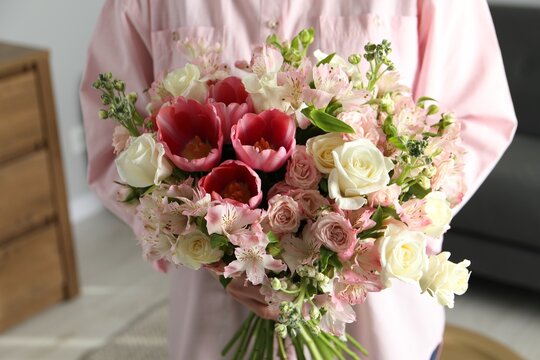 Woman with beautiful bouquet of fresh flowers indoors, closeup