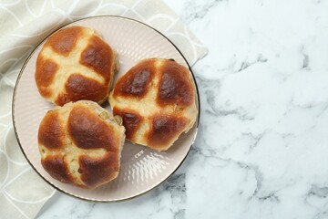 Hot cross buns on white marble table, top view. Space for text