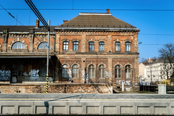 Brno, Czech Republic - March 18, 2024: Train platform at the main station in the city center with an old brick building.