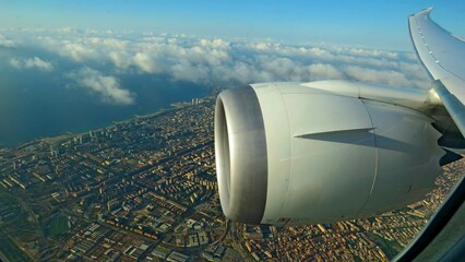 view window airplane wing engine jet flying trip Barcelona city county vacations - obrazy, fototapety, plakaty