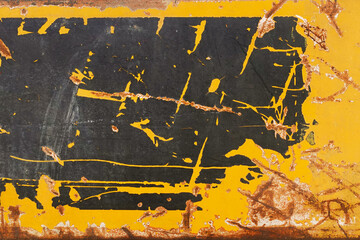scratched grungy label on yellow rusty metal weathered surface abstract background with copyspace