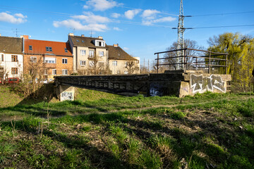 Brno, Czech Republic - Old concrete bridge over the river on the embankment street with family houses.