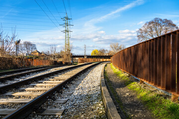Old railway tracks on the bank of the river in the industrial part of the city of Brno, Czech...