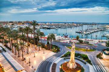 Illuminated Alicante Old Town Panorama at Dusk with Harbor