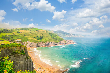 Itzurun beach and hills of Zumaia coast at summer, Pais Vasco - obrazy, fototapety, plakaty