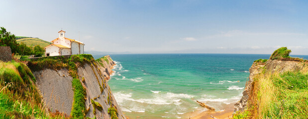 panorama of Itzurun beach and hills of Zumaia coast at summer, Pais Vasco - obrazy, fototapety, plakaty