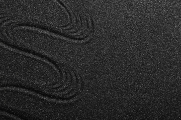 Texture of black sand with lines. Zen concept
