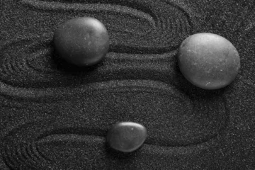 Fototapete Spa stones on black sand with lines, closeup. Zen concept © Pixel-Shot