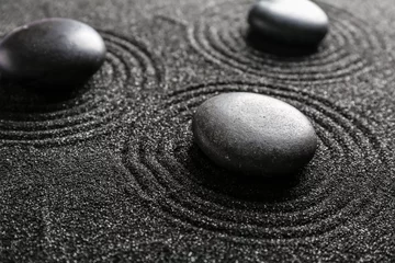 Fotobehang Spa stones on black sand with lines, closeup. Zen concept © Pixel-Shot