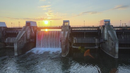 Aerial view of Hydroelectric power plant with dam during sunset. Energy production