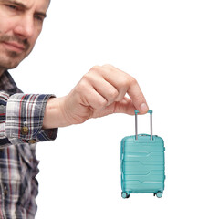 luggage and hand luggage, a miniature mint-colored suitcase on a white isolated background in the...