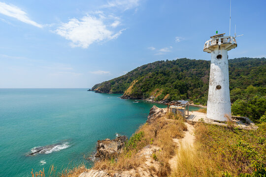 Scenic view of a lighthouse on a cliff at the Mu Ko Lanta National Park in Koh Lanta, Thailand, on a sunny day.